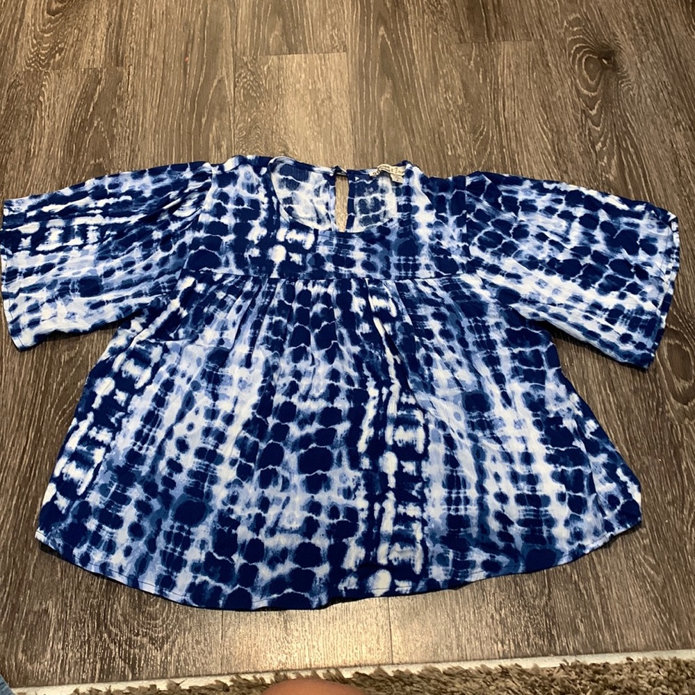 This shirt is blue and white the brand of the shirt is gypsies.
